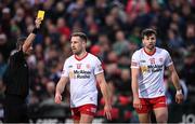 16 April 2022; Conor McKenna, right, of Tyrone is shown a yellow card by referee Joe McQuillan during the Ulster GAA Football Senior Championship preliminary round match between Fermanagh and Tyrone at Brewster Park in Enniskillen, Fermanagh. Photo by Stephen McCarthy/Sportsfile