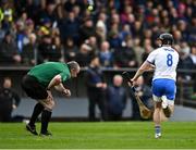 17 April 2022; Referee Johnny Murphy ducks out of the way of hand pass by Darragh Lyons of Waterford during the Munster GAA Hurling Senior Championship Round 1 match between Waterford and Tipperary at Walsh Park in Waterford. Photo by Piaras Ó Mídheach/Sportsfile