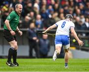 17 April 2022; Darragh Lyons of Waterford handpasses the ball as referee Johnny Murphy looks on during the Munster GAA Hurling Senior Championship Round 1 match between Waterford and Tipperary at Walsh Park in Waterford. Photo by Piaras Ó Mídheach/Sportsfile