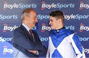 18 April 2022; Jockey Paddy O'Hanlon with An Taoiseach Micheál Martin TD after winning the BoyleSports Irish Grand National Steeplechase on Lord Lariat during day three of the Fairyhouse Easter Festival at Fairyhouse Racecourse in Ratoath, Meath. Photo by Seb Daly/Sportsfile