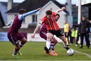 18 April 2022; Cameron McJannet of Derry City in action against Ryan Brennan, right, and Dylan Grimes of Drogheda United during the SSE Airtricity League Premier Division match between Drogheda United and Derry City at Head in the Game Park in Drogheda, Louth. Photo by Ben McShane/Sportsfile