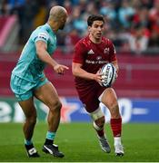 16 April 2022; Joey Carbery of Munster in action against Tom O'Flaherty of Exeter Chiefs during the Heineken Champions Cup Round of 16 Second Leg match between Munster and Exeter Chiefs at Thomond Park in Limerick. Photo by Brendan Moran/Sportsfile