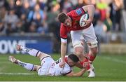 22 April 2022; Jack O'Donoghue of Munster is tackled by John Cooney of Ulster during the United Rugby Championship match between Ulster and Munster at Kingspan Stadium in Belfast. Photo by Ramsey Cardy/Sportsfile