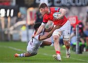 22 April 2022; Jack O'Donoghue of Munster is tackled by Robert Baloucoune of Ulster during the United Rugby Championship match between Ulster and Munster at Kingspan Stadium in Belfast. Photo by Ramsey Cardy/Sportsfile