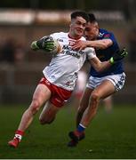 22 April 2022; Ruairí Canavan of Tyrone in action against Cormac Brady of Cavan during the EirGrid Ulster GAA Football U20 Championship Final match between Cavan and Tyrone at Brewster Park in Enniskillen, Fermanagh. Photo by David Fitzgerald/Sportsfile
