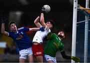 22 April 2022; Conor Cush of Tyrone in action against Eoghan Hartin, left, and Jake Norris of Cavan during the EirGrid Ulster GAA Football U20 Championship Final match between Cavan and Tyrone at Brewster Park in Enniskillen, Fermanagh. Photo by David Fitzgerald/Sportsfile