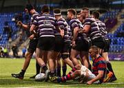 22 April 2022; Terenure College players celebrate their side's fourth try, scored by Robbie Smyth, hidden, as Dominick Damianov of Clontarf reacts during the Leinster Rugby Bank of Ireland Metropolitan Cup Final match between Terenure College and Clontarf at Energia Park in Dublin. Photo by Ben McShane/Sportsfile