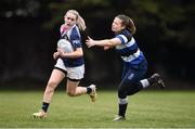 23 April 2022; Jenny Keegan of Portlaoise RFC evades the tackle of Charlie Egraz of Wanderers RFC during the Paul Cusack Plate Final match between Portlaoise RFC and Wanderers RFC at Ollie Campbell Park, Old Belvedere RFC in Dublin. Photo by Ben McShane/Sportsfile