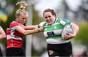 23 April 2022; Mary Healy of Naas RFC holds off the tackle of Megan McConnell of Wicklow J1 during the Paul Cusack Cup Final match between Wicklow J1 and Naas RFC at Ollie Campbell Park, Old Belvedere RFC in Dublin. Photo by Ben McShane/Sportsfile