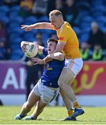 23 April 2022; Cormac O'Reilly of Cavan is tackled by Marc Jordan of Antrim during the Ulster GAA Football Senior Championship Quarter-Final match between Antrim and Cavan at Corrigan Park in Belfast. Photo by Ramsey Cardy/Sportsfile