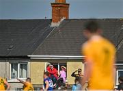 23 April 2022; Supporters watch on from nearby houses during the Ulster GAA Football Senior Championship Quarter-Final match between Antrim and Cavan at Corrigan Park in Belfast. Photo by Ramsey Cardy/Sportsfile