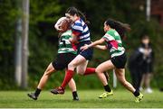 23 April 2022; Roisin Crowe of Blackrock RFC J1 in action against Ruth Weakliam, left, and Laura Brown of Balbriggan RFC during the Paul Flood Plate Final match between Blackrock RFC J1 and Balbriggan RFC at Ollie Campbell Park, Old Belvedere RFC in Dublin. Photo by Ben McShane/Sportsfile
