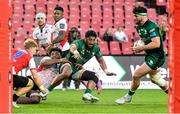 23 April 2022; Bundee Aki of Connacht is tackled by Vincent Tshituka of Emirates Lions as he makes a pass to team-mate Tom Daly who scored their side's second try during the United Rugby Championship match between Emirates Lions and Connacht at Emirates Airline Park in Johannesburg, South Africa. Photo by Sydney Seshibedi/Sportsfile