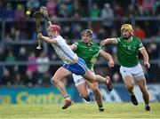 23 April 2022; Calum Lyons of Waterford in action against Darragh O'Donovan and Tom Morrisey, right, of Limerick during the Munster GAA Hurling Senior Championship Round 2 match between Limerick and Waterford at TUS Gaelic Grounds in Limerick. Photo by Stephen McCarthy/Sportsfile