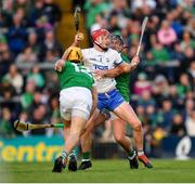 23 April 2022; Calum Lyons of Waterford is tackled by Tom Morrisey, 12, and Darragh O'Donovan of Limerick during the Munster GAA Hurling Senior Championship Round 2 match between Limerick and Waterford at TUS Gaelic Grounds in Limerick. Photo by Ray McManus/Sportsfile