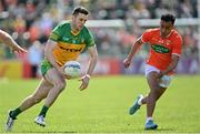 24 April 2022; Eoghan Ban Gallagher of Donegal in action against Jemar Hall of Armagh during the Ulster GAA Football Senior Championship Quarter-Final match between Donegal and Armagh at Páirc MacCumhaill in Ballybofey, Donegal. Photo by Ramsey Cardy/Sportsfile