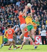 24 April 2022; Donegal players, from left, Jason McGee, and Michael Langan compete for possession with Rian O'Neill of Armagh during the Ulster GAA Football Senior Championship Quarter-Final match between Donegal and Armagh at Páirc MacCumhaill in Ballybofey, Donegal. Photo by Ramsey Cardy/Sportsfile