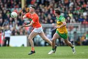 24 April 2022; Connaire Mackin of Armagh in action against Peadar Mogan of Donegal during the Ulster GAA Football Senior Championship Quarter-Final match between Donegal and Armagh at Páirc MacCumhaill in Ballybofey, Donegal. Photo by Ramsey Cardy/Sportsfile