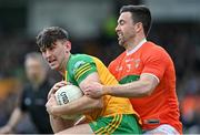 24 April 2022; Michael Langan of Donegal is tackled by Aidan Forker of Armagh during the Ulster GAA Football Senior Championship Quarter-Final match between Donegal and Armagh at Páirc MacCumhaill in Ballybofey, Donegal. Photo by Ramsey Cardy/Sportsfile