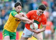 24 April 2022; Ben Crealey of Armagh in action against Conor O'Donnell of Donegal during the Ulster GAA Football Senior Championship Quarter-Final match between Donegal and Armagh at Páirc MacCumhaill in Ballybofey, Donegal. Photo by Ramsey Cardy/Sportsfile