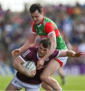 24 April 2022; Liam Silke of Galway is tackled by Diarmuid O'Connor of Mayo during the Connacht GAA Football Senior Championship Quarter-Final match between Mayo and Galway at Hastings Insurance MacHale Park in Castlebar, Mayo. Photo by Brendan Moran/Sportsfile