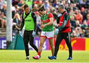 24 April 2022; Oisín Mullin of Mayo leaves the pitch, accompanied by chartered physiotherapist Garrett Coughlan, left, and Dr Sean Moffatt during the Connacht GAA Football Senior Championship Quarter-Final match between Mayo and Galway at Hastings Insurance MacHale Park in Castlebar, Mayo. Photo by Brendan Moran/Sportsfile