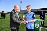 26 April 2022; FAI president Gerry McAnaney presents the Man of the Match award to Matthew Scott of UCD after the Collingwood Cup Final match between UCD and Queens University Belfast at Oriel Park in Dundalk, Louth. Photo by Ben McShane/Sportsfile