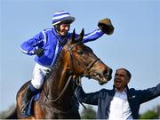 26 April 2022; Jockey Paul Townend celebrates by taking groom Imran Haider's hat onboard Energumene after they won the William Hill Champion Steeplechase during day one of the Punchestown Festival at Punchestown Racecourse in Kildare. Photo by David Fitzgerald/Sportsfile