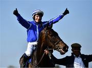 26 April 2022; Jockey Paul Townend celebrates on Energumene after they won the William Hill Champion Steeplechase alongside groom Imran Haider during day one of the Punchestown Festival at Punchestown Racecourse in Kildare. Photo by David Fitzgerald/Sportsfile