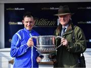 26 April 2022; Jockey Paul Townend and trainer Willie Mullins celebrate with the Blessington Cup after winning the William Hill Champion Steeplechase with Energumene during day one of the Punchestown Festival at Punchestown Racecourse in Kildare. Photo by David Fitzgerald/Sportsfile