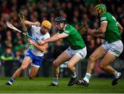 23 April 2022; Jack Prendergast of Waterford is tackled by Limerick players Diarmaid Byrnes and Dan Morrisey during the Munster GAA Hurling Senior Championship Round 2 match between Limerick and Waterford at TUS Gaelic Grounds in Limerick. Photo by Ray McManus/Sportsfile