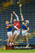 27 April 2022; Ben O’Connor of Cork in action against Peter McGarry and Ed Connolly of Tipperary during the oneills.com Munster GAA Hurling U20 Championship semi-final match between Tipperary and Cork at FBD Semple Stadium in Thurles, Tipperary. Photo by Diarmuid Greene/Sportsfile