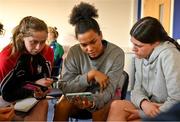 27 April 2022; Rachel Murphy, left, Eimear Corri and Jade Gaffney study video clips during a Leinster Rugby women's squad workshop at Energia Park in Dublin. Photo by Brendan Moran/Sportsfile