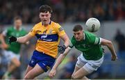 30 April 2022; Gavin Cooney of Clare in action against Brian Fanning of Limerick during the Munster GAA Senior Football Championship Quarter-Final match between Clare and Limerick at Cusack Park in Ennis, Clare. Photo by Piaras Ó Mídheach/Sportsfile