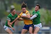 30 April 2022; Cian O'Dea of Clare in action against Limerick players Hugh Bourke, left, and Brian Donovan during the Munster GAA Senior Football Championship Quarter-Final match between Clare and Limerick at Cusack Park in Ennis, Clare. Photo by Piaras Ó Mídheach/Sportsfile