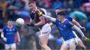 30 April 2022; Ray Connellan of Westmeath gets a pass away depite the attention of Iarla O'Sullivan of Longford during the Leinster GAA Football Senior Championship Quarter-Final match between Westmeath and Longford at TEG Cusack Park in Mullingar, Westmeath. Photo by Ben McShane/Sportsfile