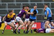 30 April 2022; Brian Fenton of Dublin in action against Niall Hughes of Wexford during the Leinster GAA Football Senior Championship Quarter-Final match between Wexford and Dublin at Chadwicks Wexford Park in Wexford. Photo by Ray McManus/Sportsfile