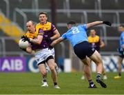 30 April 2022; Kevin O'Grady of Wexford in action against Brian Fenton of Dublin during the Leinster GAA Football Senior Championship Quarter-Final match between Wexford and Dublin at Chadwicks Wexford Park in Wexford. Photo by Ray McManus/Sportsfile