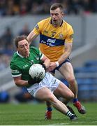 30 April 2022; Peter Nash of Limerick in action against Ciarán Russell of Clare during the Munster GAA Senior Football Championship Quarter-Final match between Clare and Limerick at Cusack Park in Ennis, Clare. Photo by Piaras Ó Mídheach/Sportsfile