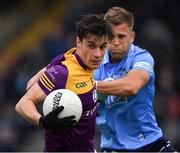 30 April 2022; Paidí Hughes of Wexford in action against Jonny Cooper of Dublin during the Leinster GAA Football Senior Championship Quarter-Final match between Wexford and Dublin at Chadwicks Wexford Park in Wexford. Photo by Ray McManus/Sportsfile