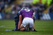 30 April 2022; The Dublin doctor Dermot Smith attends to Wexford's Liam Coleman during the Leinster GAA Football Senior Championship Quarter-Final match between Wexford and Dublin at Chadwicks Wexford Park in Wexford. Photo by Ray McManus/Sportsfile