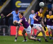 30 April 2022; Lorcan O'Dell of Dublin kicks a late point under pressure from Martin O'Connor of Wexford during the Leinster GAA Football Senior Championship Quarter-Final match between Wexford and Dublin at Chadwicks Wexford Park in Wexford. Photo by Ray McManus/Sportsfile