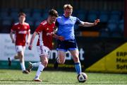 26 April 2022; Eoin Farrell of UCD and Matt Doherty of Queen's University Belfast during the Collingwood Cup Final match between UCD and Queens University Belfast at Oriel Park in Dundalk, Louth. Photo by Ben McShane/Sportsfile