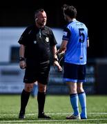 26 April 2022; Referee Eddie Reilly with Gearoid Mulligan of UCD during the Collingwood Cup Final match between UCD and Queens University Belfast at Oriel Park in Dundalk, Louth. Photo by Ben McShane/Sportsfile