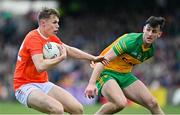 24 April 2022; Oisin O'Neill of Armagh in action against Michael Langan of Donegal during the Ulster GAA Football Senior Championship Quarter-Final match between Donegal and Armagh at Páirc MacCumhaill in Ballybofey, Donegal. Photo by Ramsey Cardy/Sportsfile