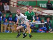 27 April 2022; Shane O'Brien of Limerick in action against Josh Fitzgerald of Waterford during the oneills.com Munster GAA Hurling U20 Championship Semi-Final match between Limerick and Waterford at TUS Gaelic Grounds in Limerick, Ireland. Photo by Michael P Ryan/Sportsfile