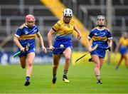 1 May 2022; Eimear Kelly of Clare races clear of Aoife McGrath, left, and Grace O'Brien of Tipperary during the Munster Senior Camogie Championship Semi-Final match between Clare and Tipperary at FBD Semple Stadium in Thurles, Tipperary. Photo by Ray McManus/Sportsfile