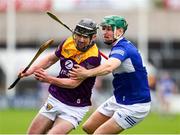 1 May 2022; Connal Flood of Wexford in action against Sean Downey of Laois during the Leinster GAA Hurling Senior Championship Round 3 match between Laois and Wexford at MW Hire O’Moore Park in Portlaoise, Laois. Photo by Michael P Ryan/Sportsfile