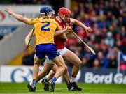 1 May 2022; Alan Connolly on his way to kick a goal for Cork despite being tackled by Clare players, from left, Rory Hayes and Diarmuid Ryan during the Munster GAA Hurling Senior Championship Round 3 match between Cork and Clare at FBD Semple Stadium in Thurles, Tipperary. Photo by Ray McManus/Sportsfile