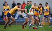 30 April 2022; Hugh Bourke of Limerick in action against Clare players Manus Doherty, left, and Cian O'Dea during the Munster GAA Senior Football Championship Quarter-Final match between Clare and Limerick at Cusack Park in Ennis, Clare. Photo by Piaras Ó Mídheach/Sportsfile